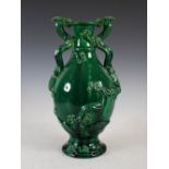 A green glazed ceramic twin handled dragon vase, early 20th century, 40cm high.