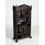 A small Chinese dark wood display cabinet, late Qing Dynasty, the pierced cornice carved with