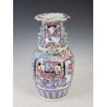 A Chinese porcelain famille rose vase, Qing Dynasty, decorated with panels of Court figures on a