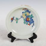 A Japanese Kakiemon dish, decorated with a chrysanthemum and foliate spray in red, yellow, green and