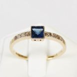 An early 20th century yellow and white metal sapphire and diamond set cocktail ring, centred with