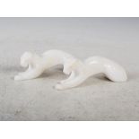 A pair of Art Deco white alabaster recumbent Panthers, 17cm long x 5.5cm high.