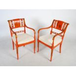 A pair of orange ground chinoiserie decorated armchairs in the Regency style, 20th century, the