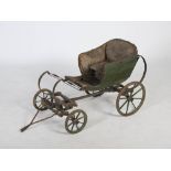 A George III painted pine child's carriage, the upholstered back and arms with brass studded detail,