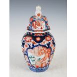 A Japanese Imari porcelain octagonal shaped jar and cover, decorated with shaped panels enclosing