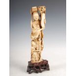 A Chinese ivory figure group of Guanyin and attendant boy, Qing Dynasty, on carved and pierced