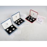 The Royal Mint, three proof sets, comprising: a 1984-1987 United Kingdom £1 Silver Proof Four Coin