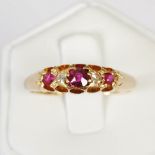 An Edwardian 18ct gold, ruby and diamond five stone ring, set with a graduated row of three round