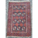 A Persian rug, early 20th century, the rectangular chocolate brown coloured ground decorated with