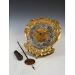 An Arts & Crafts brass and white metal 'wag at the wa' wall clock, the white metal chapter ring