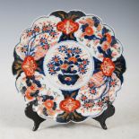 A Japanese Imari porcelain plate, Meiji Period, decorated with a circular panel enclosing urn