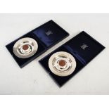 The Royal Mint, a pair of late 20th century commemorative silver dishes, London, makers mark CNL,