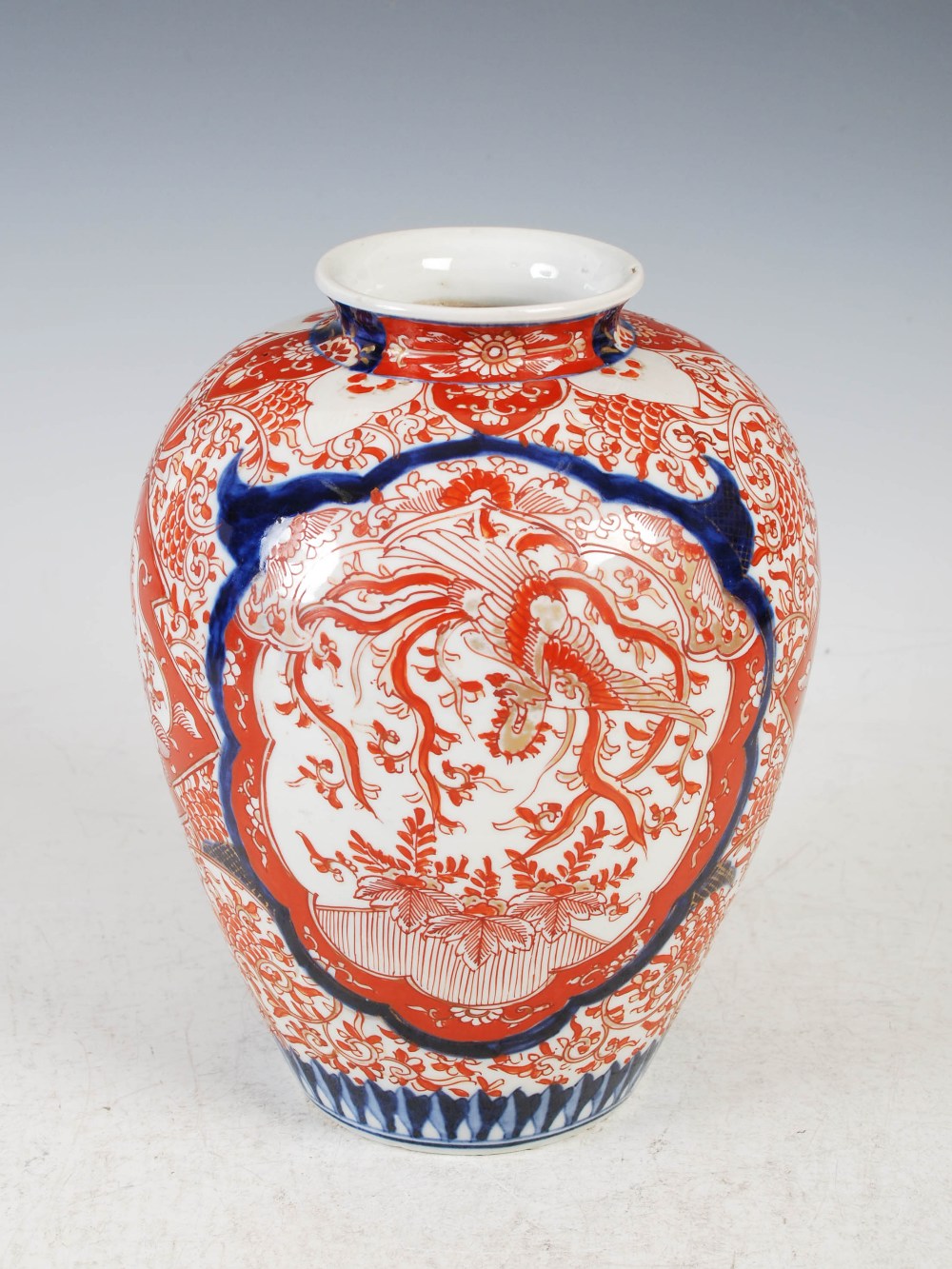 A Japanese Imari vase, late 19th/early 20th century, decorated with oval shaped panels enclosing