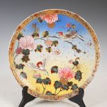 A Japanese Satsuma pottery charger, Meiji Period, with polychrome decoration of birds on flowering