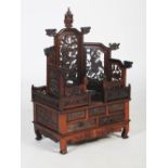A Chinese dark wood dressing stand, Qing Dynasty, the upper section fitted with a seven panelled