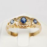 An Edwardian 18ct gold, sapphire and diamond set five stone ring, central navette shaped panel set
