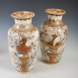 A pair of Japanese Satsuma pottery vases, Meiji Period, decorated with pagoda shaped bird stands,