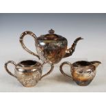 A Chinese silver three piece tea set, Qing Dynasty, makers mark of LH, probably that of Luen Hing,
