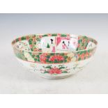 A Japanese porcelain punch bowl, decorated in the Chinese taste with panels of figures, peony and