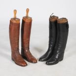 Two pairs of vintage leather riding boots and treen shoe trees, one black pair with boot trees by