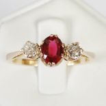 A yellow metal, garnet topped doublet and diamond three stone, centred with an oval faceted garnet