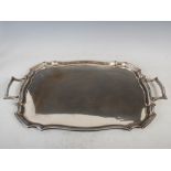 A George V silver twin handled serving tray, London, 1918, makers mark of HE & CO. LD., of shaped