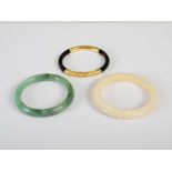 Three assorted Chinese bangles, Qing Dynasty, comprising: a yellow metal mounted tortoiseshell