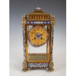 A late 19th/early 20th century gilt metal and champleve enamel mantel clock, the circular dial