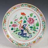 A Chinese porcelain famille rose charger, Qing Dynasty, decorated with a circular panel enclosing