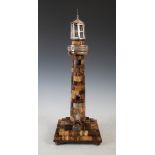 A 19th century banded agate and white metal mounted presentation model of a lighthouse, with white