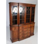 A George III style mahogany breakfront secretaire bookcase, the moulded cornice and dentil frieze
