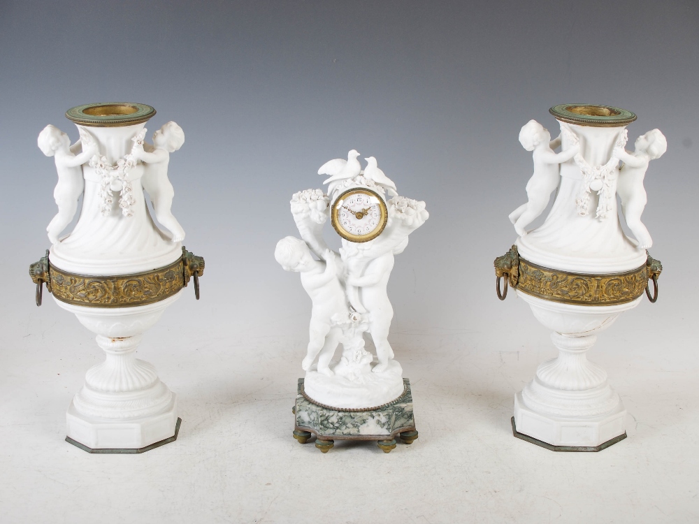 A late 19th/ early 20th century bisque porcelain, onyx and gilt metal clock garniture, the