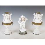 A late 19th/ early 20th century bisque porcelain, onyx and gilt metal clock garniture, the