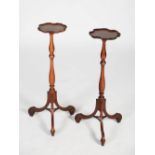 A pair of late 19th/early 20th century mahogany jardiniere stands, the dished circular tops raised