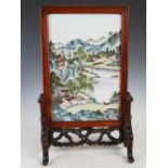 A Chinese porcelain and dark wood table screen, the dark wood rectangular frame enclosing a