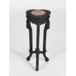 An unusual Chinese dark wood jardiniere stand, Qing Dynasty, the trefoil shaped top centred with a