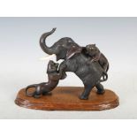 A Japanese bronze and ivory elephant and tiger group, Meiji Period, signed, and shaped wooden