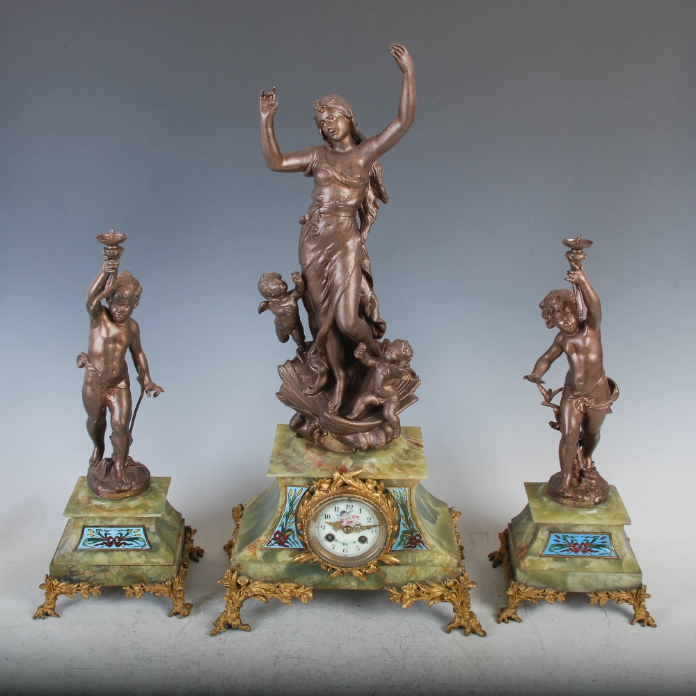 A late 19th/ early 20th century spelter, onyx and champleve enamel clock garniture, the clock with