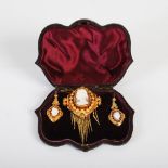 A suite of Victorian yellow metal cameo set jewellery, comprising: brooch with fringed detail and