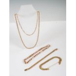 A collection of yellow metal necklaces and bracelets, comprising: yellow metal necklace stamped