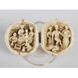 A late 19th century Northern European two sectional ivory ball carved with narrative scene, open 9.