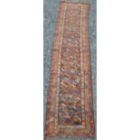 A Persian runner, late 19th/early 20th century, the rectangular blue ground field with polychrome