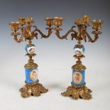 A pair of late 19th century ormolu and porcelain mounted three light candelabra, the bleu celeste