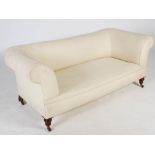 A 19th century mahogany sofa, the upholstered back, arms and seat raised on tapered cylindrical ring