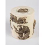 A Japanese ivory cylindrical box and cover, Meiji Period, carved in relief with monkeys, 7.5cm