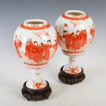 A pair of Chinese porcelain lanterns on integral wood stands, Qing Dynasty, decorated in rouge-de-