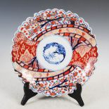 A Japanese Imari porcelain charger, late 19th/early 20th century, decorated with circular shaped