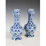 A pair of Chinese porcelain blue and white garlic neck bottle vases, Qing Dynasty, bearing Kangxi