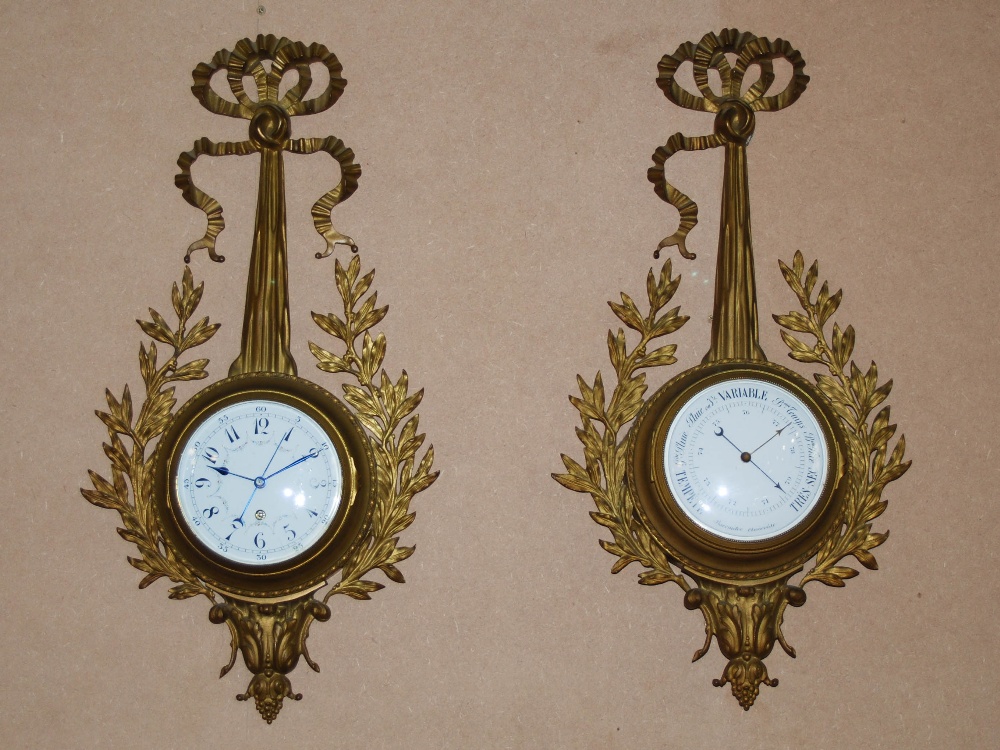 A late 19th/ early 20th century French gilt metal wall clock and matching barometer, both with white