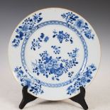 A Chinese porcelain blue and white charger, Qing Dynasty, decorated with scattered foliate sprays